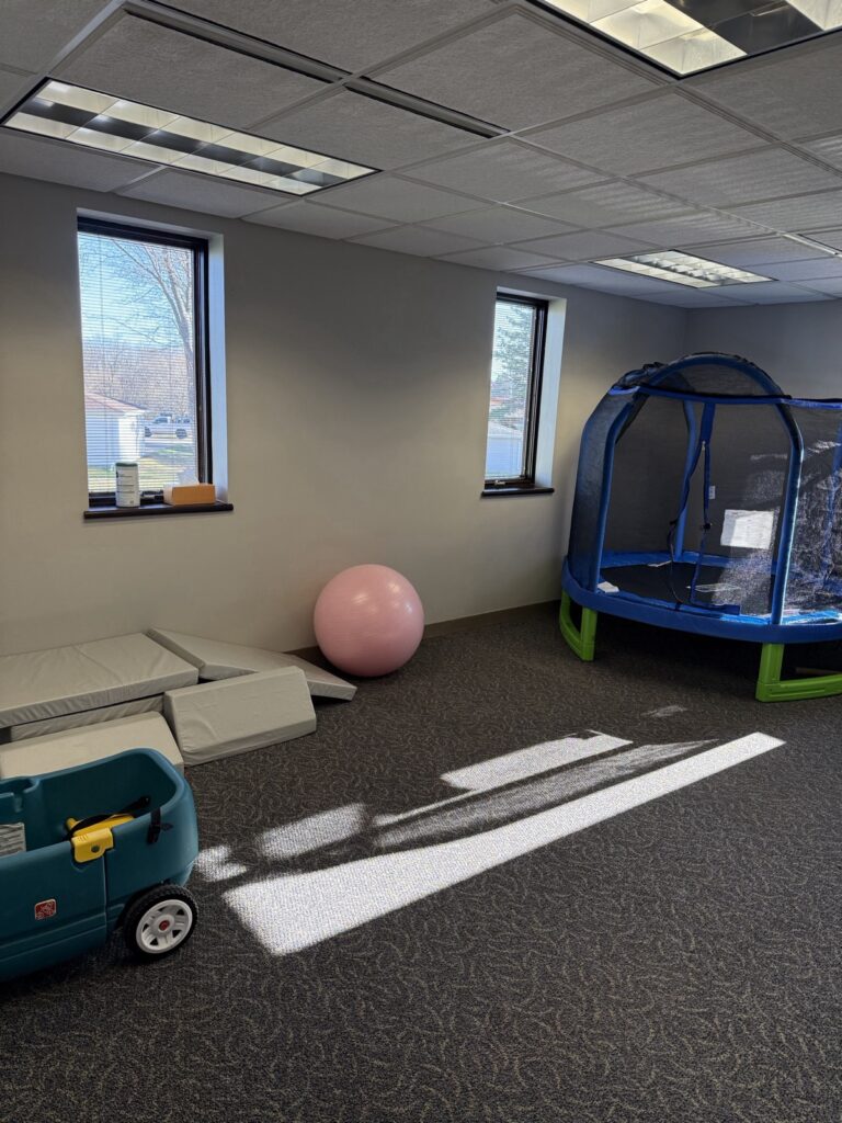 Movement room with a trampoline, exercise ball and soft play mats